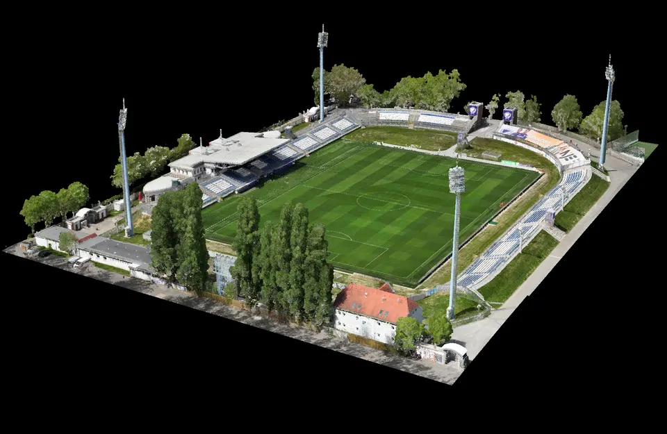 Színes háromdimenziós pontfelhő egy labdarúgó-stadionról a lelátókkal, a világítótornyokkal és a környező épületekkel